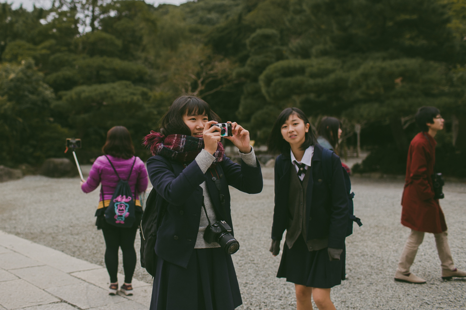 Japanese teenage students taking pictures - The cat, you and us