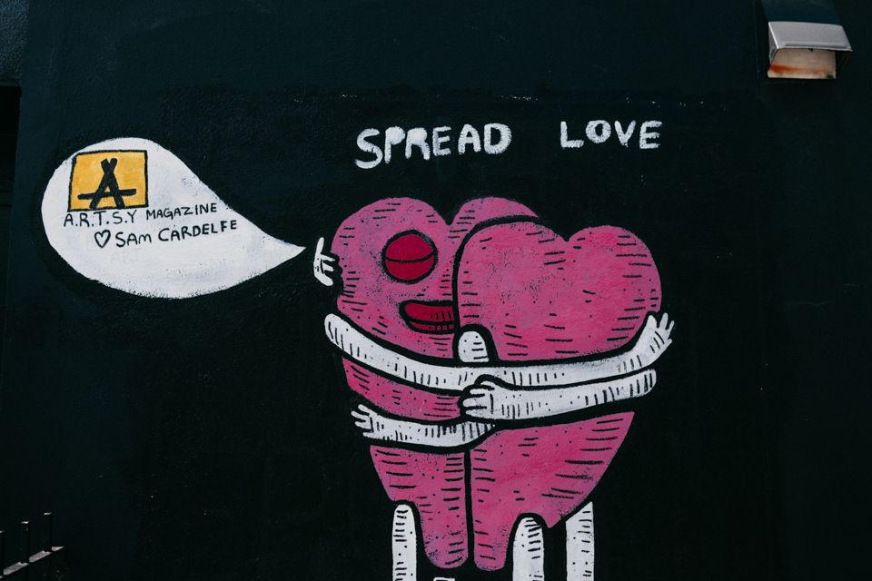 Brookyn Spread Love graffiti closeup - The cat, you and us